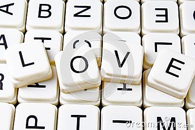 Love text word crossword title caption label cover background. Alphabet letter toy blocks. White alphabetical letters. Stock Photo