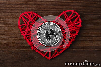 Love to bitcoins. Coin Bitcoin lies on a red heart Stock Photo