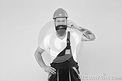 Love to work in garage. engineer in uniform. man builder in hard hat. keep head safe in helmet. building improvement and Stock Photo