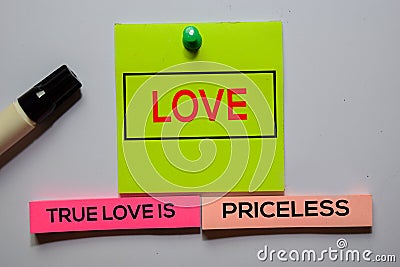 Love. True Love Is Priceless text on sticky notes isolated on office desk Stock Photo