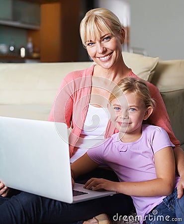 They love using their laptop. A family using their laptop while sitti. Stock Photo