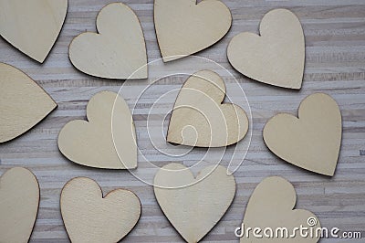 Love Valentines day background, group of light wooden hearts spread on gray striped table, flat lay Stock Photo