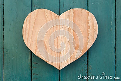 Love Valentines wooden heart on turquoise painted background Stock Photo