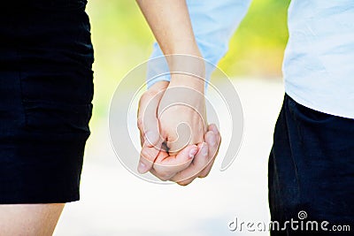 Love, waiting for the baby. Couple, pregnant woman and man, in colorful flying clothes, hold hands Pregnancy, maternity, preparati Stock Photo