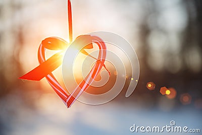 Love in winter. Heart shaped symbol Valentine Day. heart with hands, Feelings and Lifestyle concept on the sunset light Stock Photo