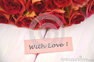 With love wishes and bouquet of gorgeous red roses Stock Photo