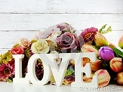 Love word wooden letter with artificial flowers decor Stock Photo