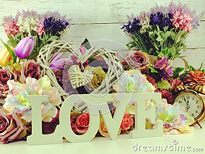 Love word wooden letter with artificial flowers decor Stock Photo