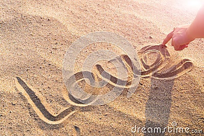 LOVE word writing on the white sand nature on the beach. summer trip Stock Photo