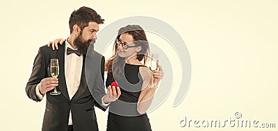 Love you so much. making marriage proposal. tuxedo man present jewel ring in box to woman. couple drink champagne for Stock Photo