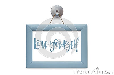 Love yourself. Modern calligraphy. Motivational quote. Blue phot Stock Photo