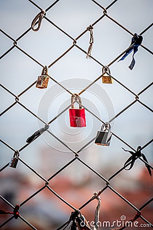 Lovelocks: The romantic tradition of sweethearts locking padlocks to a fence on a bridge, symbolizing their enduring love for each Editorial Stock Photo