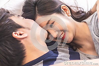 Lovely attractive young Asian couple man kiss forehead of happy woman with and hug in romantic moment. Warm heart marriage and lov Stock Photo