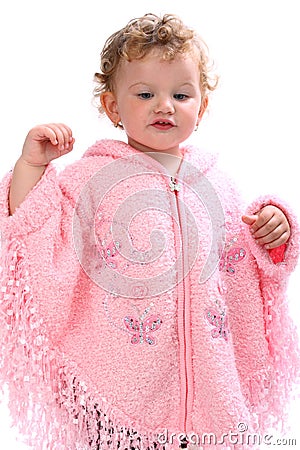 Lovely baby in pink poncho looking like an angel Stock Photo