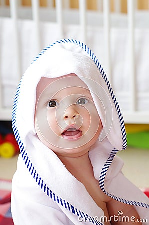 Lovely baby after shower wrapped in towel Stock Photo