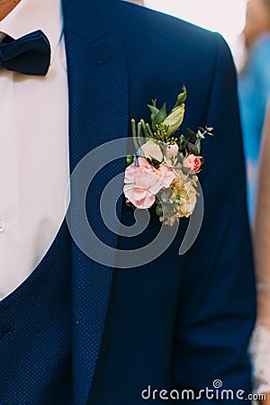 Lovely boutonniere of colourful roses on the jacket of the groom. Stock Photo