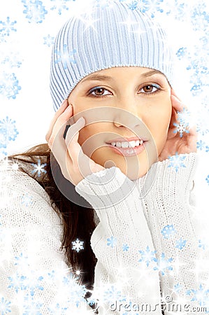 Lovely brunette in winter hat with snowflakes Stock Photo