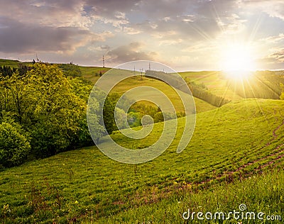 Lovely countryside with grassy hills at sunset Stock Photo