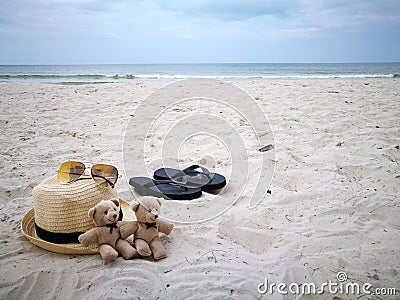 Lovely couple bear with white hat on balcony on white sand beach with Hat at Hua Hin beach, can see riding horse activity, item an Stock Photo