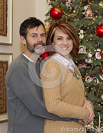 Lovely Couple embracing at Christmas Stock Photo