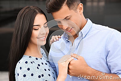 Lovely couple looking at beautiful engagement ring outdoors Stock Photo