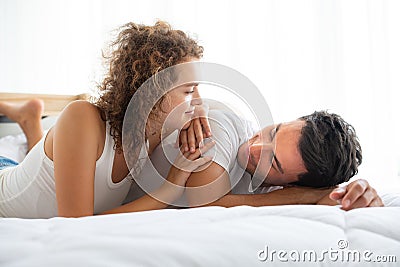 Lovely couples relax in the white bedroom Stock Photo