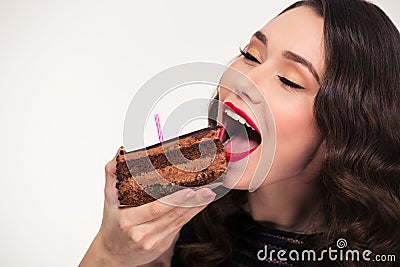 Lovely cute girl eating piece of chocolate birthday cake Stock Photo