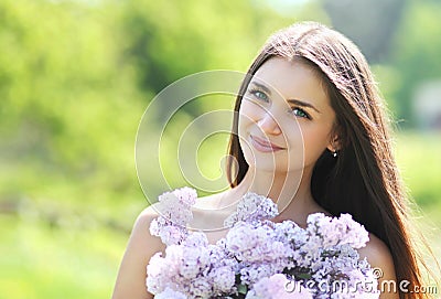 Lovely cute smiling girl with a bouquet of lilacs Stock Photo