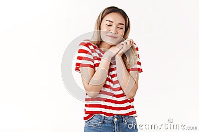 Lovely dreams tend come true. Dreamy cute tender asian blond girl close eyes smiling glad romantically imaging perfect Stock Photo