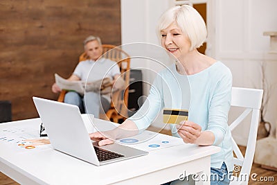 Lovely enthusiastic lady shopping online Stock Photo