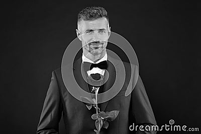 Lovely face of male. groom in tuxedo with rose. during wedding ceremony. groom in wedding jacket. bowtie is principal Stock Photo