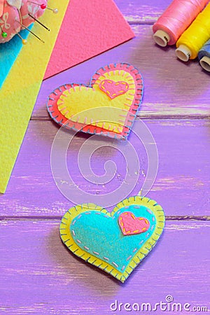 Lovely felt hearts. Valentines Day symbols. Cute homemade Valentines day gifts. Simple hand sewing project for kids. Vertical phot Stock Photo