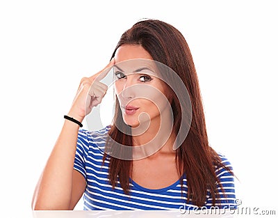 Lovely female pointing to her forehead Stock Photo