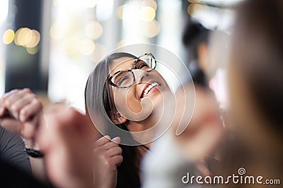 Lovely girl cheering success with coleagues and friends at a cafe. Looking up Stock Photo