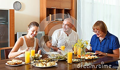 Lovely happy multigeneration family having healthy dinner Stock Photo