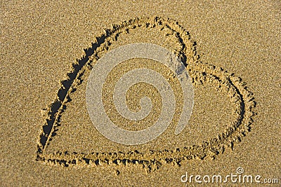 Lovely heart in sand at the beach Stock Photo