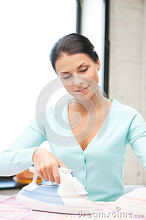 Lovely housewife with iron Stock Photo