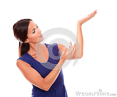 Lovely latin girl in purple dress holding palm up Stock Photo