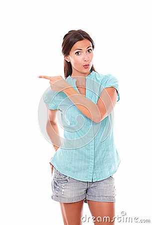 Lovely latin woman pointing to her right Stock Photo