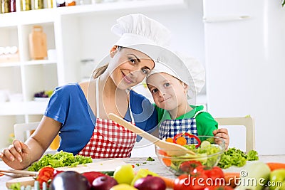 Lovely mother and kid two chefs in the kitchen Stock Photo