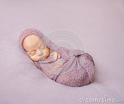 Lovely newborn swaddled in pink diaper Stock Photo