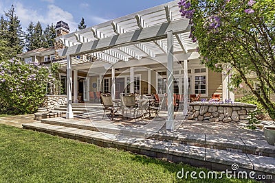 Lovely outdoor deck patio space with white dining pergola. Stock Photo