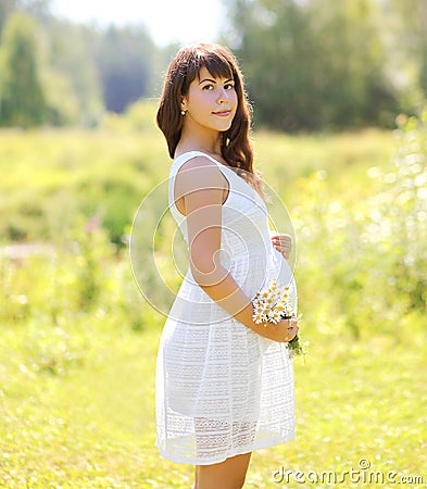Lovely pregnant woman and flowers Stock Photo