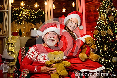 Lovely present. Family tradition. Toys collection. Happy childhood. Child enjoy christmas with grandfather Santa claus Stock Photo
