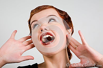 Lovely red-head young woman with surprised look Stock Photo