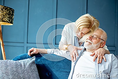 Lovely senior couple on the couch at home Stock Photo