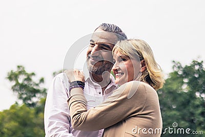 Lovely senior elderly smiling couple man and woman with happy hug or embrace in romantic moment. Warm heart marriage and lover bon Stock Photo