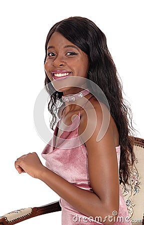Smiling woman sitting on old armchair Stock Photo