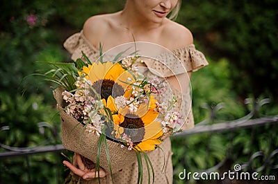 Lovely stylish bouquet with sunflowers in the hands woman Stock Photo