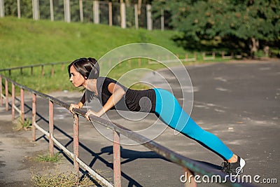 Lovely tanned woman athlete doing workout at the stadium in sunny weather. Copy space Stock Photo